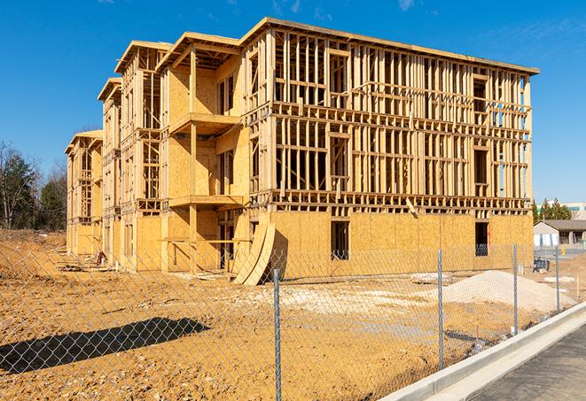 a temporary chain link fence in front of a building under construction, ensuring public safety in Colonie NY